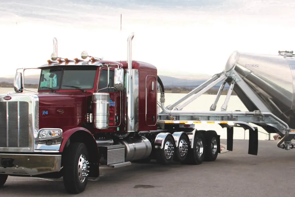 Red TransPro truck pulling a polished trailer